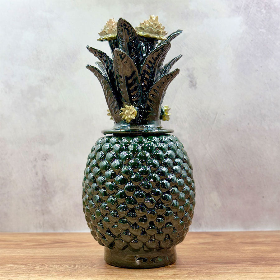 Green pineapple barrel design with white flowers made of glazed clay