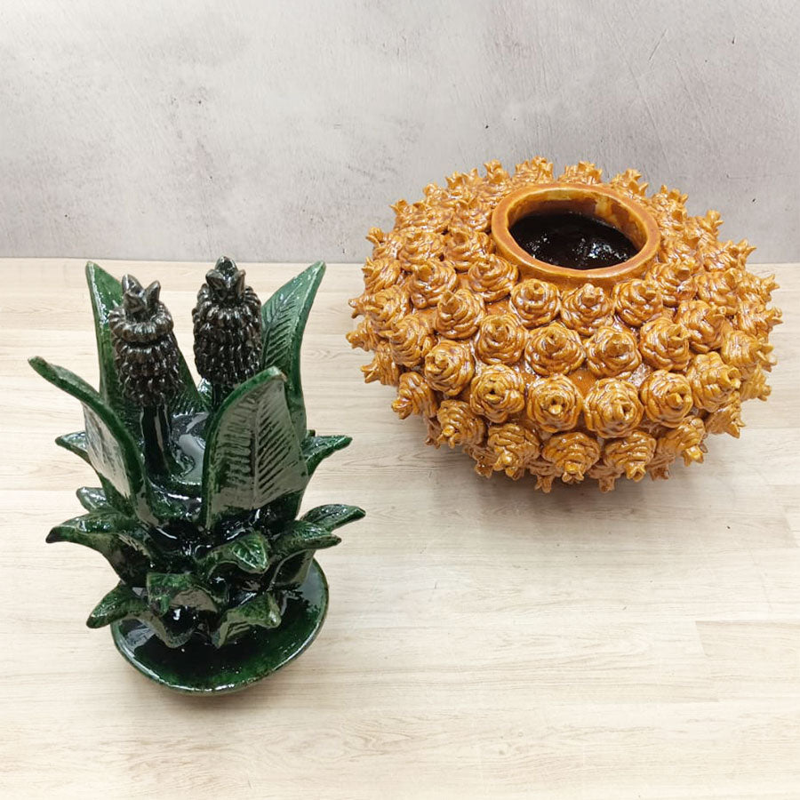 Yellow pineapple "pirinola" design with green lid made of glazed clay