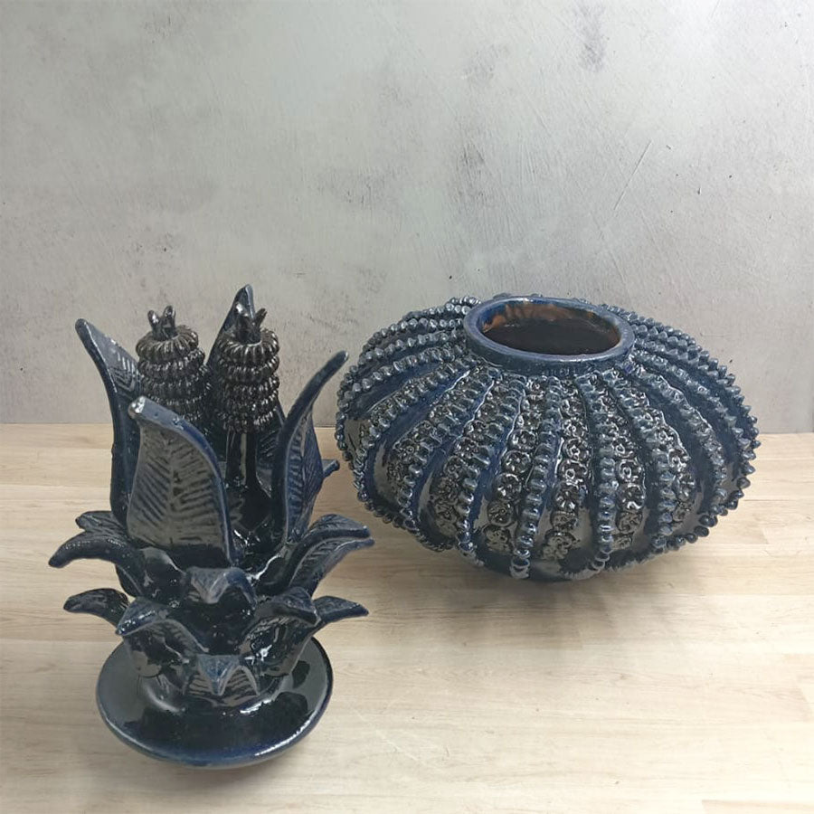 Navy blue pineapple with a spinning top design in glazed clay