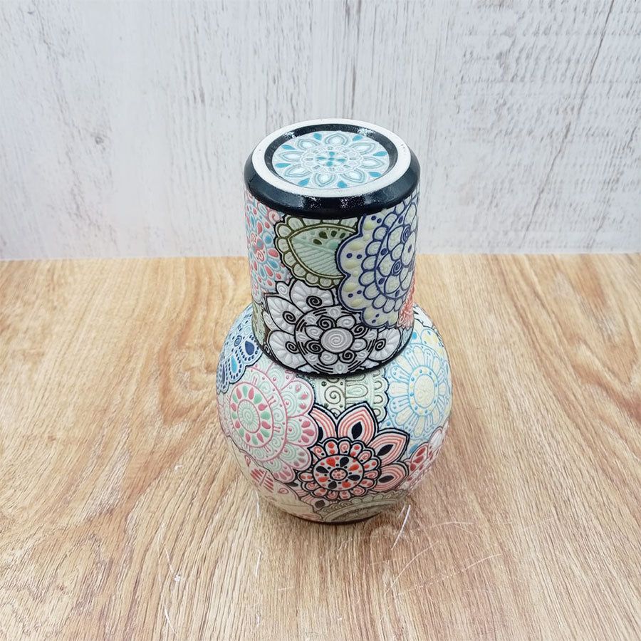 Decanter and tumbler set with a multicolored design