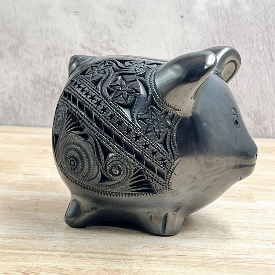 Little pig decorated with black clay