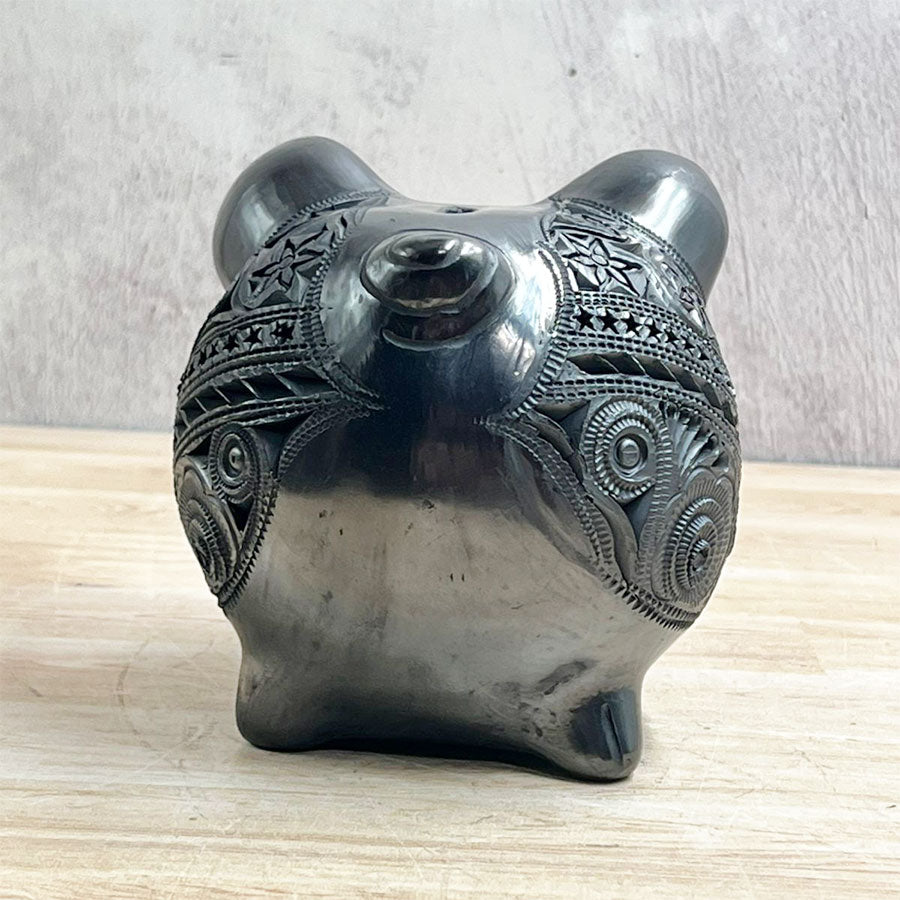 Little pig decorated with black clay