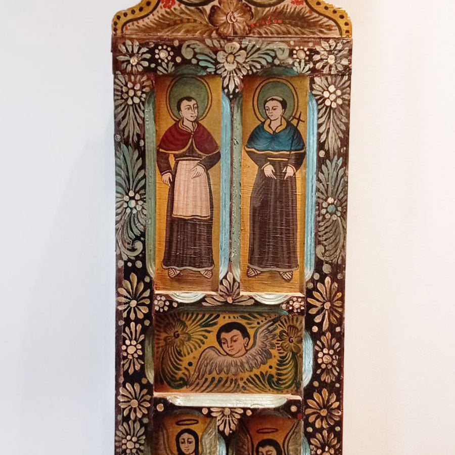 Wooden door decorated with angels and saints