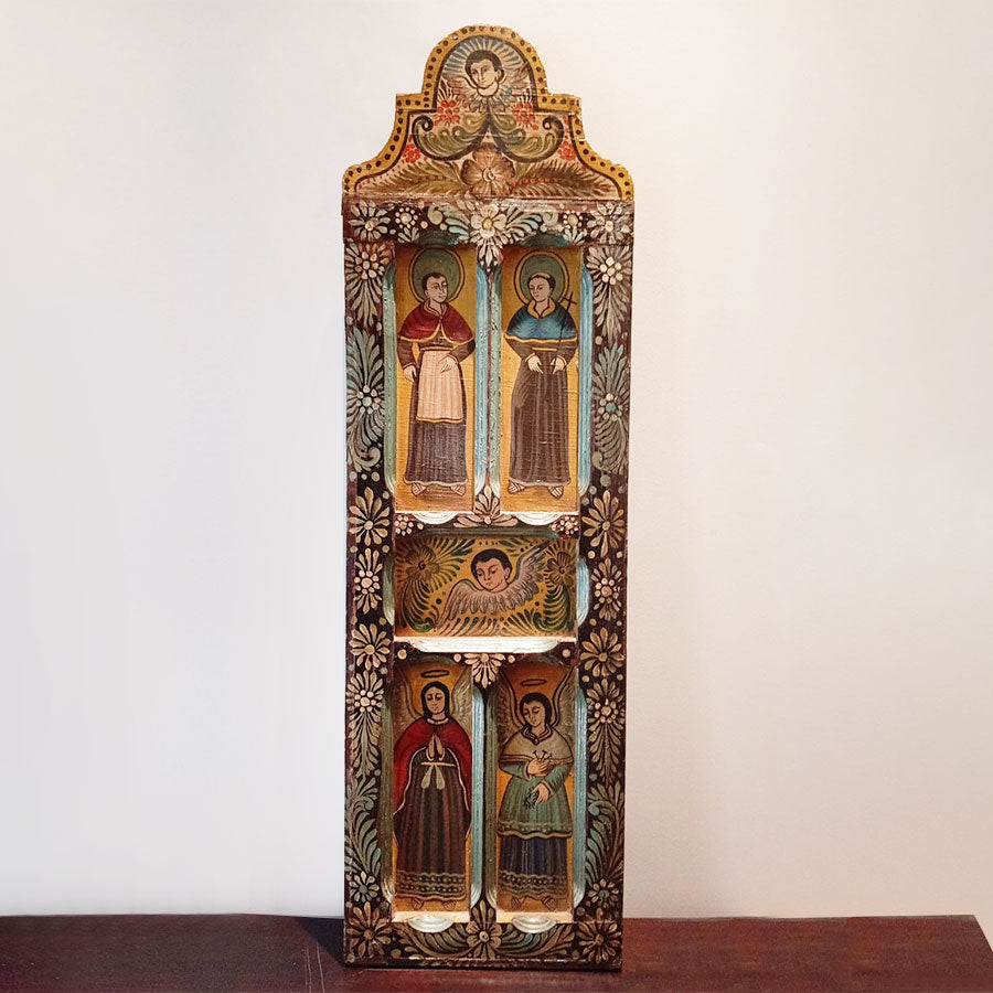 Wooden door decorated with angels and saints