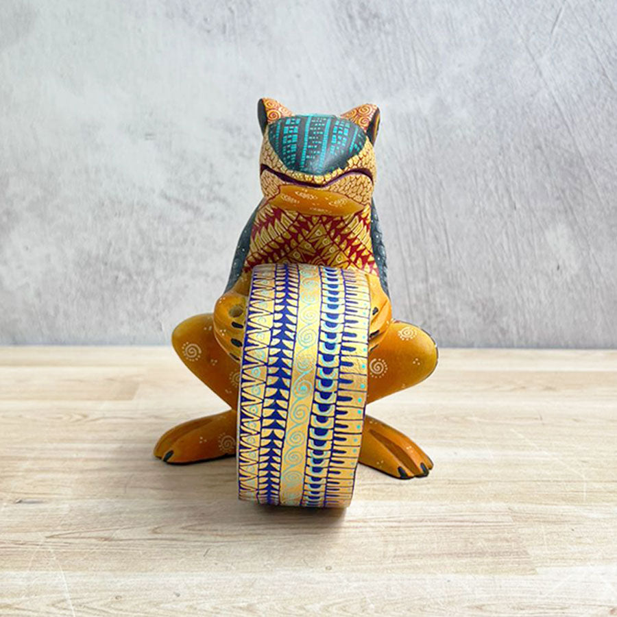 Yellow alebrije frog with drum