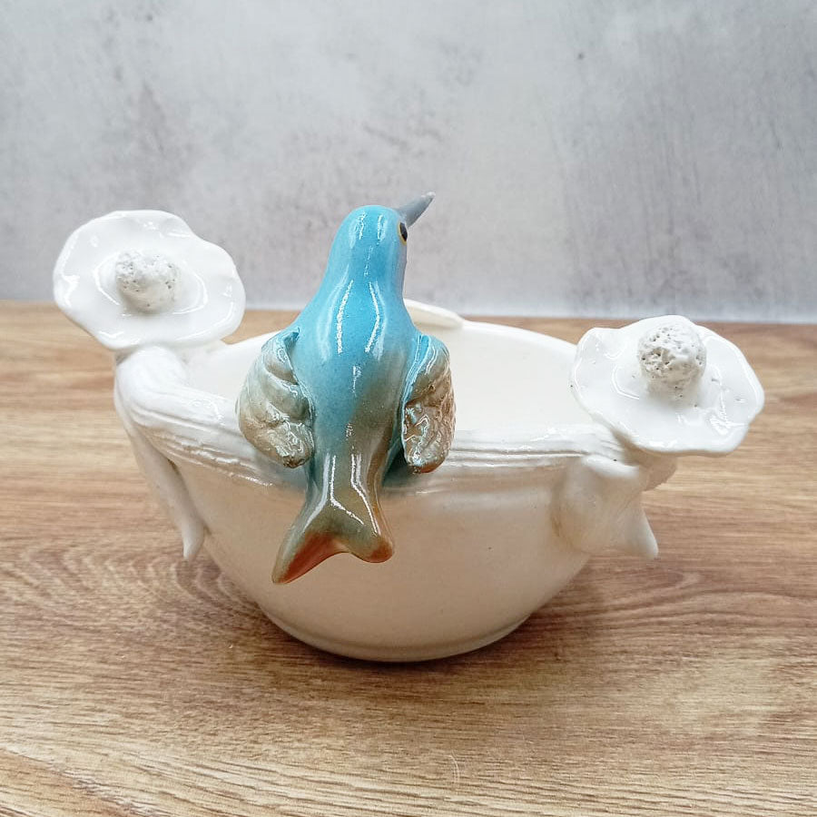 White bowl with colorful little bird